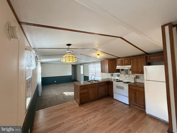 a kitchen with refrigerator and cabinets