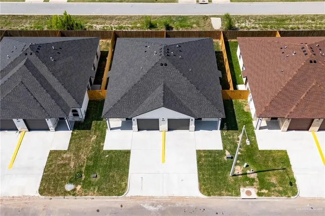 an aerial view of a house with a yard