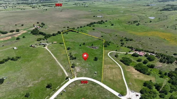 an aerial view of a houses with a back yard