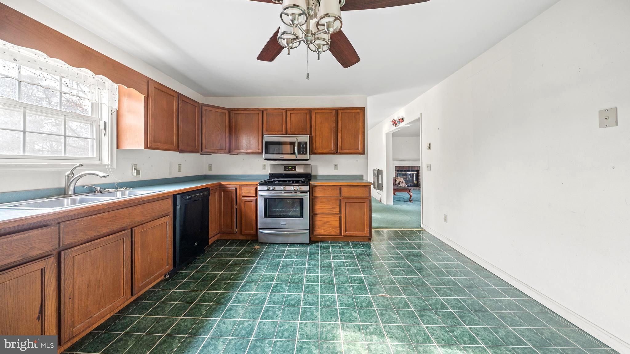 34157 Somerset Road Pocomoke City, MD 21851 - Photo 5 of 39 a kitchen with stainless steel appliances a sink window and cabinets