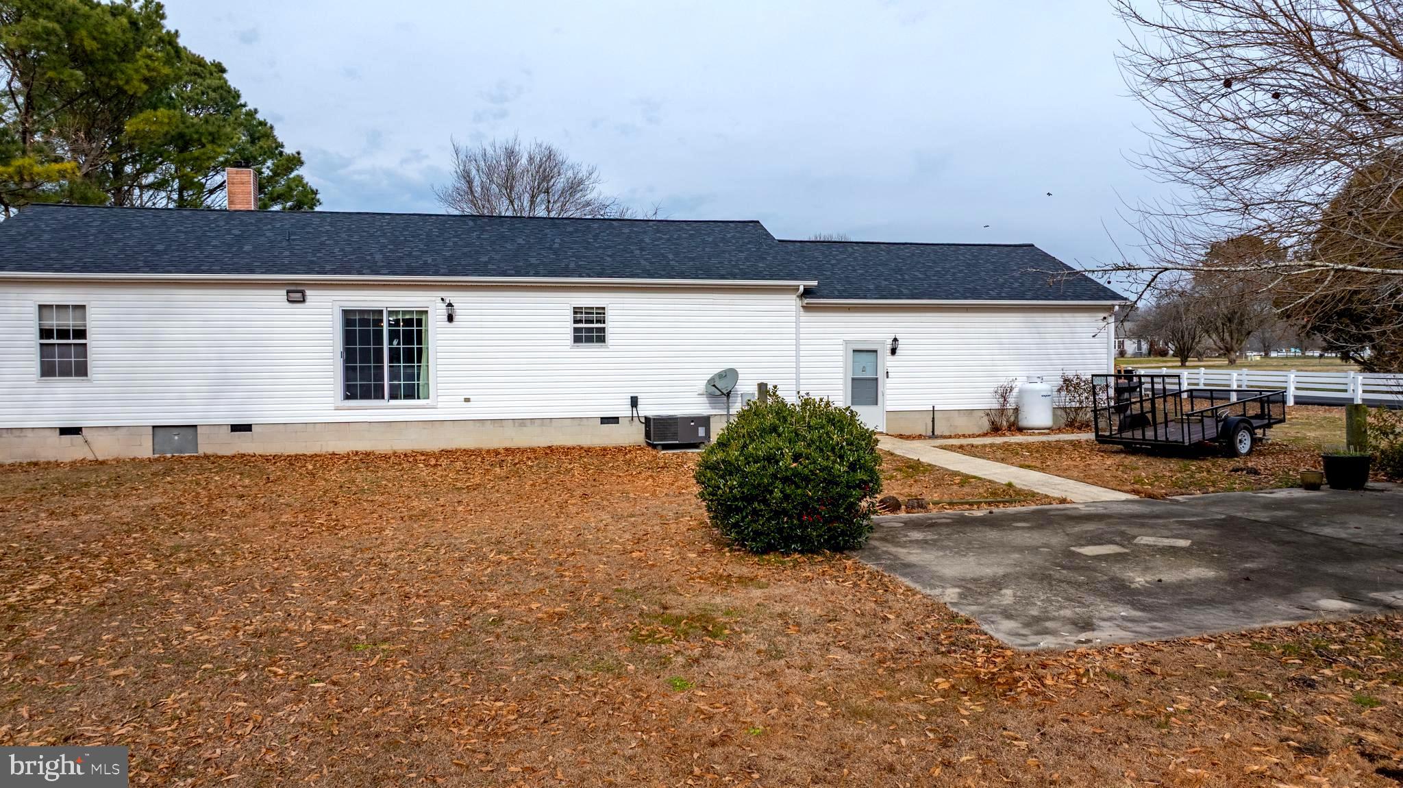 34157 Somerset Road Pocomoke City, MD 21851 - Photo 5 of 39 a front view of a house with a yard and garage