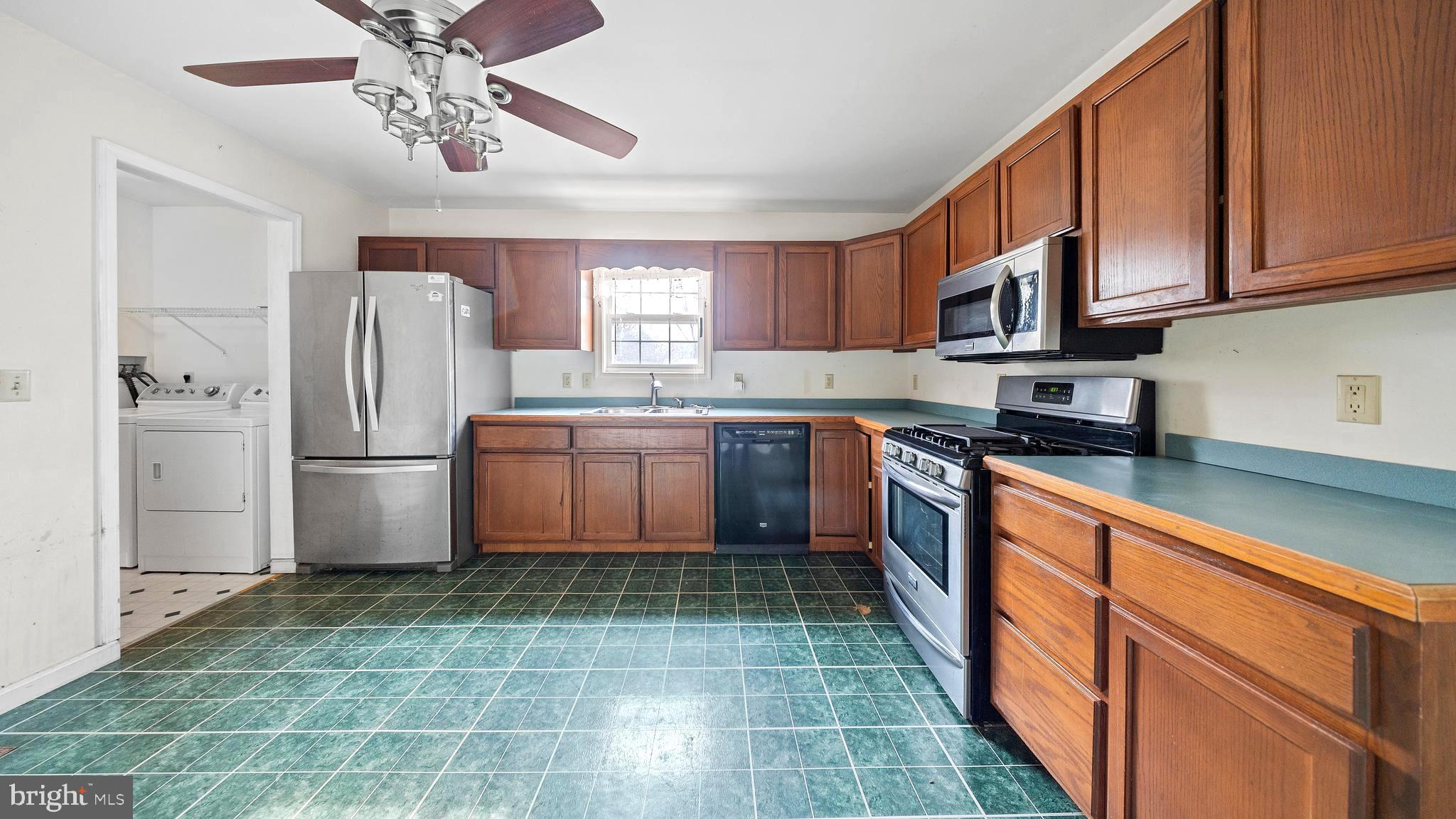 34157 Somerset Road Pocomoke City, MD 21851 - Photo 7 of 39 a kitchen with stainless steel appliances granite countertop a refrigerator sink and cabinets