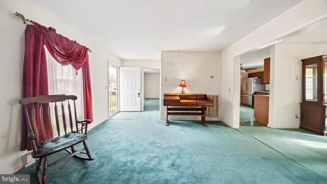a view of a livingroom with furniture and staircase