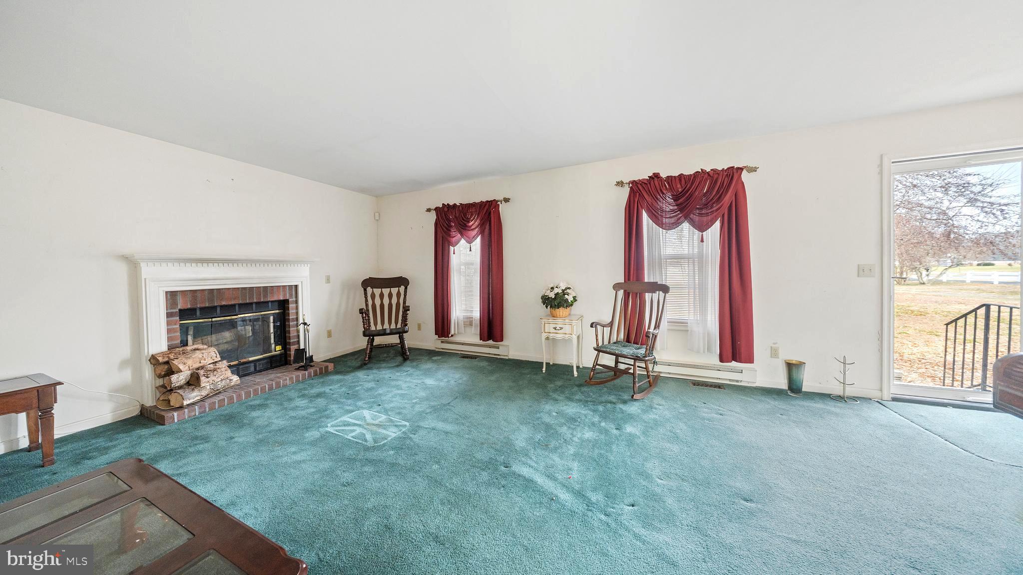 34157 Somerset Road Pocomoke City, MD 21851 - Photo 10 of 39 a view of an empty room with a fireplace and a window