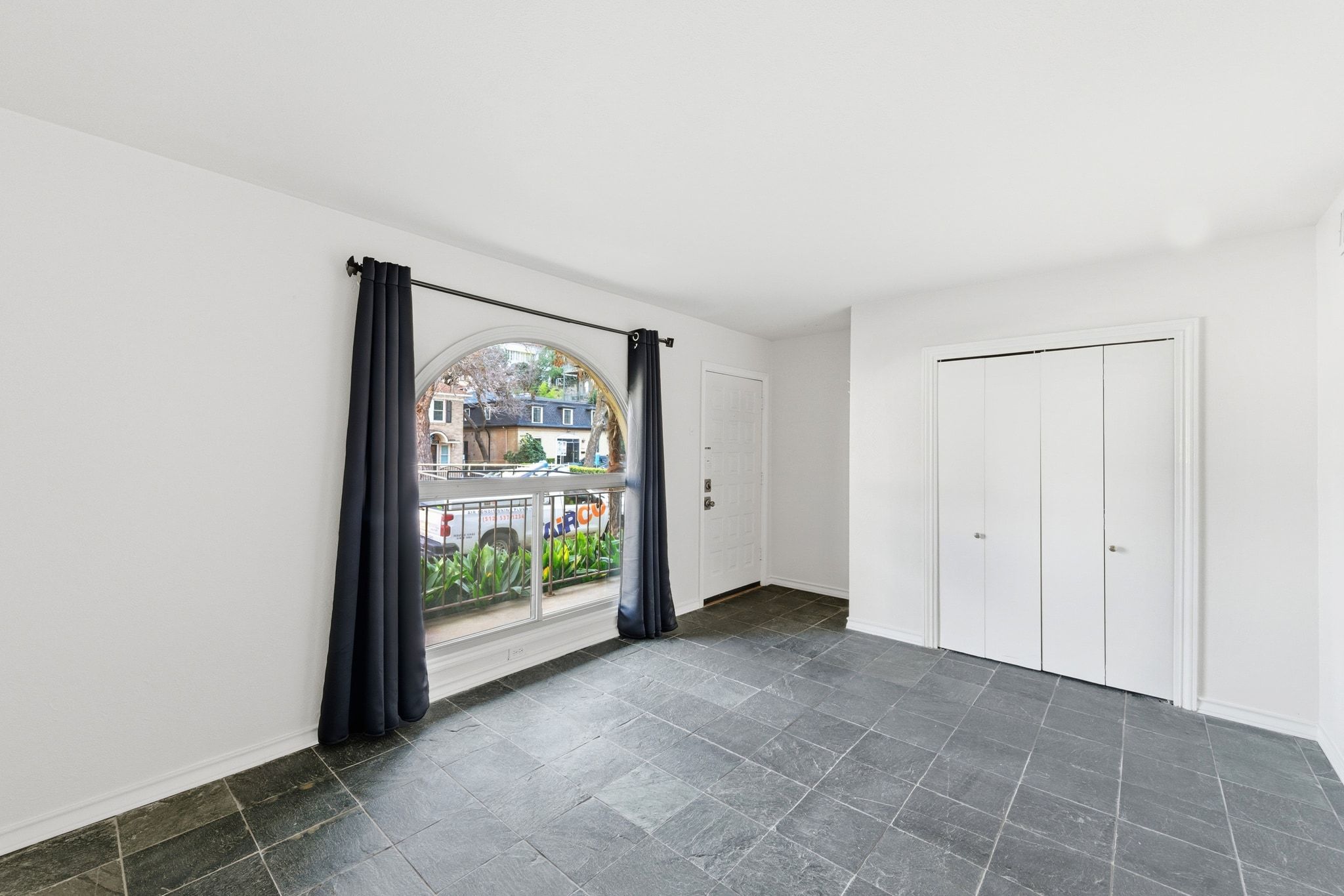 505 West 7th Street, Unit 106 Austin, TX 78701 - Photo 16 of 21 Unfurnished bedroom featuring dark stone finish flooring and a closet