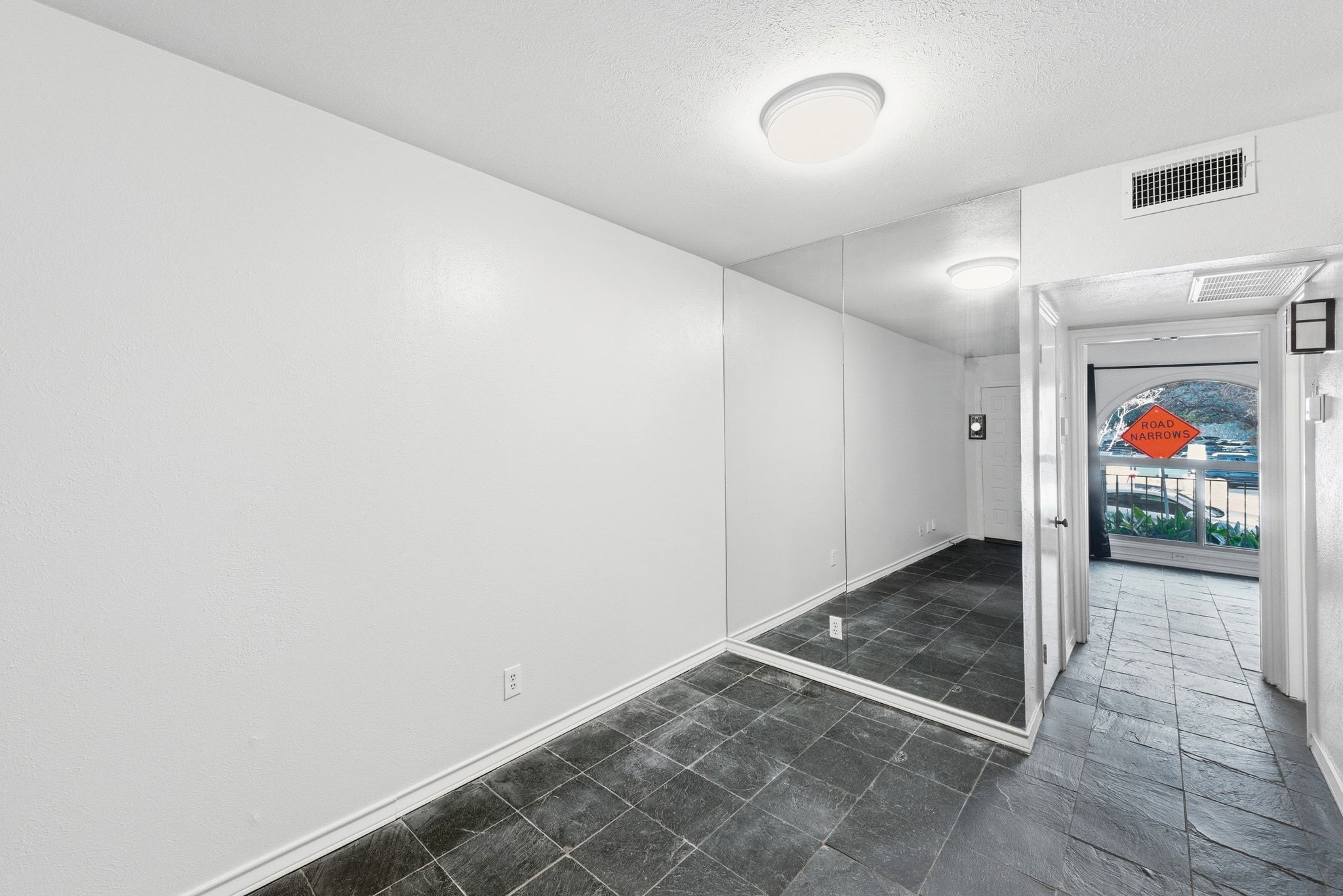 505 West 7th Street, Unit 106 Austin, TX 78701 - Photo 19 of 21 Unfurnished room featuring baseboards and dark stone finish flooring