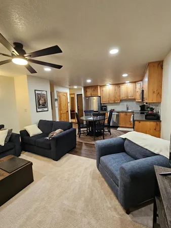 a living room with furniture and a view of kitchen