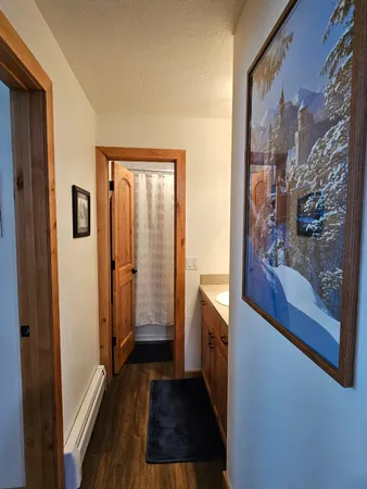 a bedroom with a bed and painting on the wall