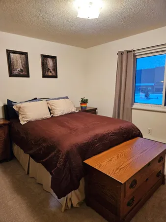 a bedroom with a bed and a window