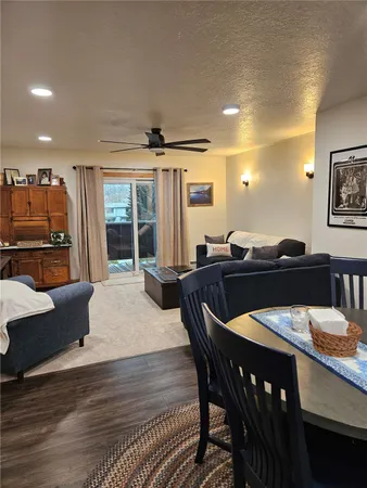 a view of a a dining room with furniture window and wooden floor