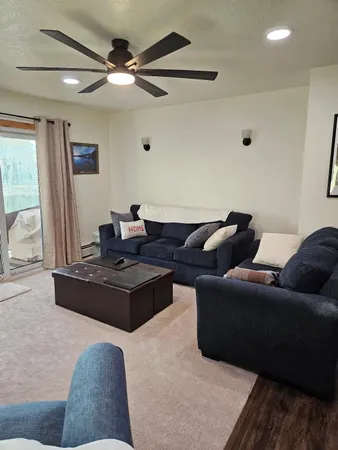 a living room with furniture and a chandelier