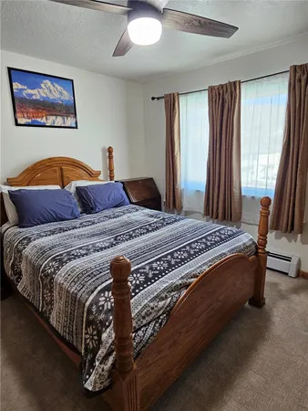 a bedroom with a bed and a mirror