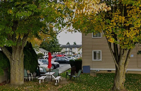 a backyard of a house with table and chairs