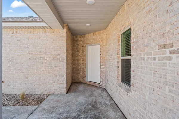a view of a hallway with brick walls