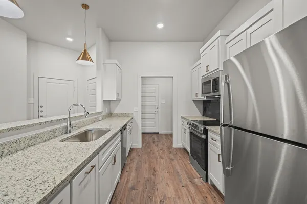 a kitchen with a sink a refrigerator and a sink