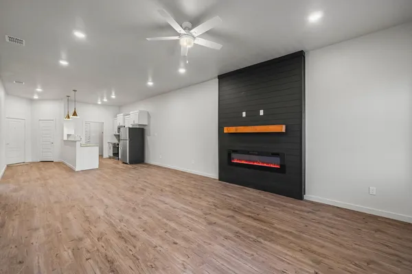 a view of an empty room with a kitchen