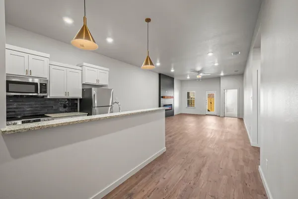 a view of a kitchen with a sink and microwave