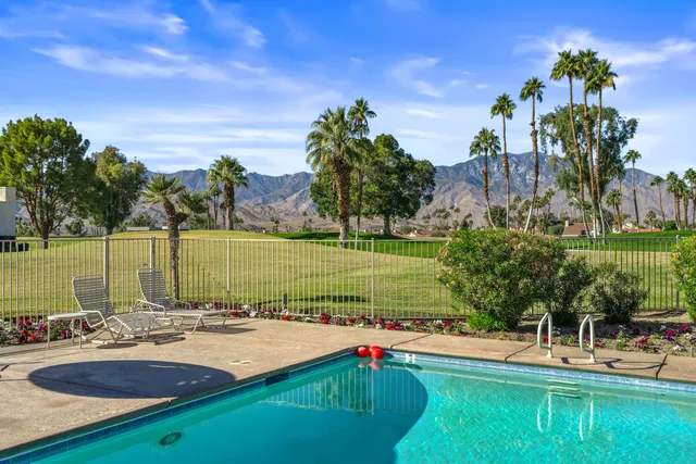a view of a swimming pool and lounge chairs