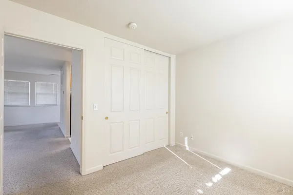 an empty room with closet area