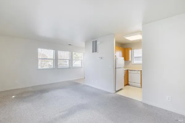 a view of washer and dryer with kitchen view