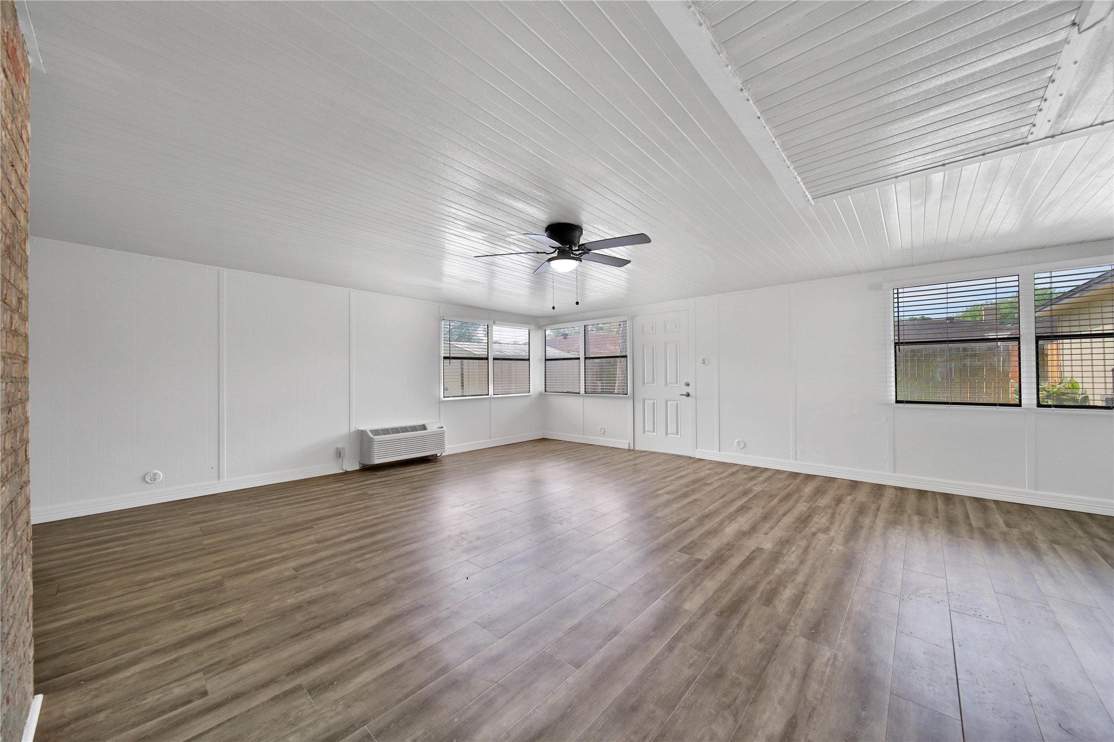 9411 Roos Road Houston, TX 77036 - Photo 14 of 41 wooden floor in an empty room with a window