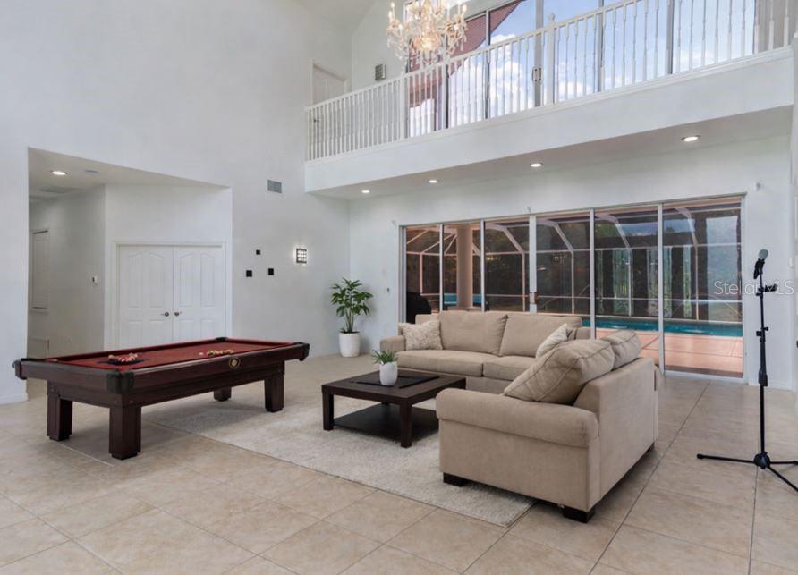 6151 New Osprey Point Weeki Wachee, FL 34607 - Photo 15 of 63 a living room with furniture lamp and a large window