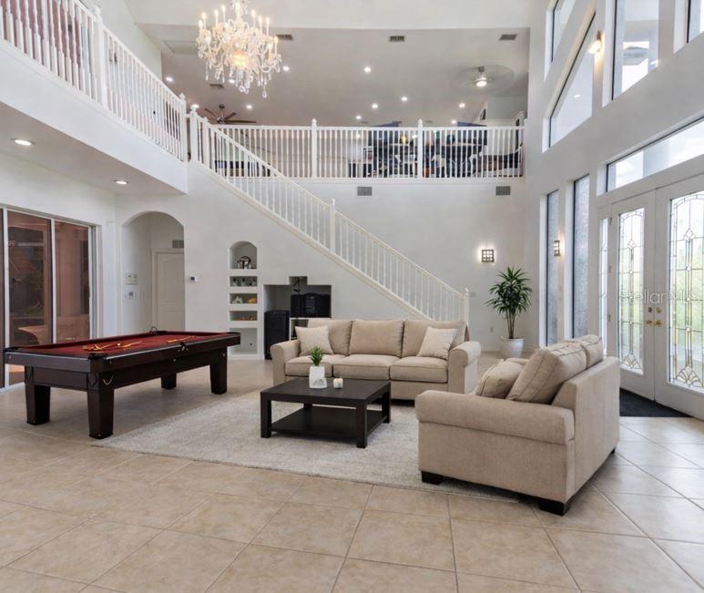 6151 New Osprey Point Weeki Wachee, FL 34607 - Photo 16 of 63 a living room with furniture and wooden floor
