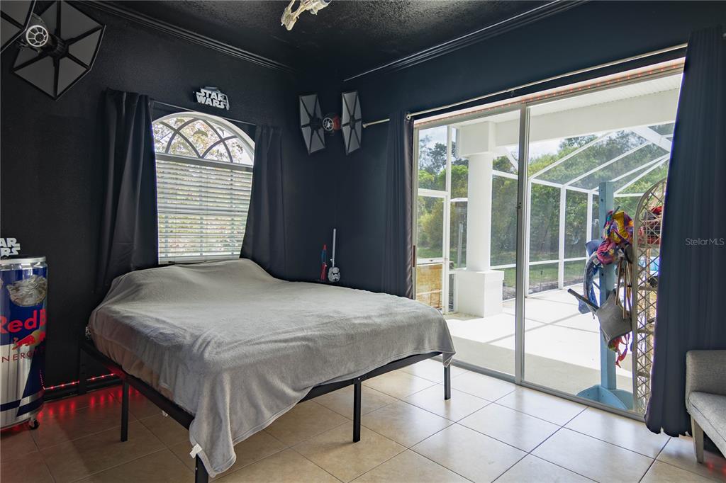 6151 New Osprey Point Weeki Wachee, FL 34607 - Photo 18 of 63 a bedroom with a bed and a large window