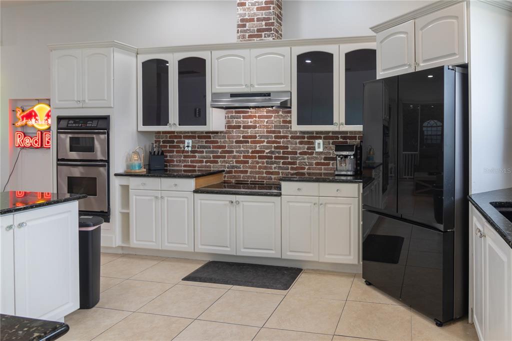 6151 New Osprey Point Weeki Wachee, FL 34607 - Photo 26 of 63 a kitchen with stainless steel appliances a refrigerator and sink