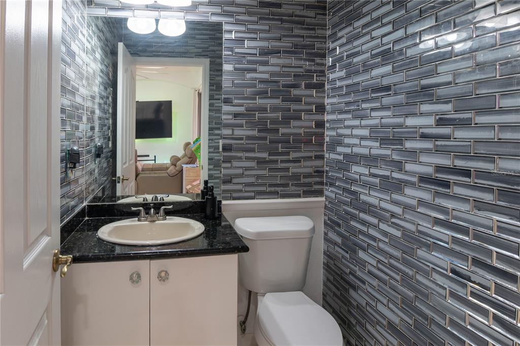 6151 New Osprey Point Weeki Wachee, FL 34607 - Photo 37 of 63 a bathroom with a toilet a sink and mirror