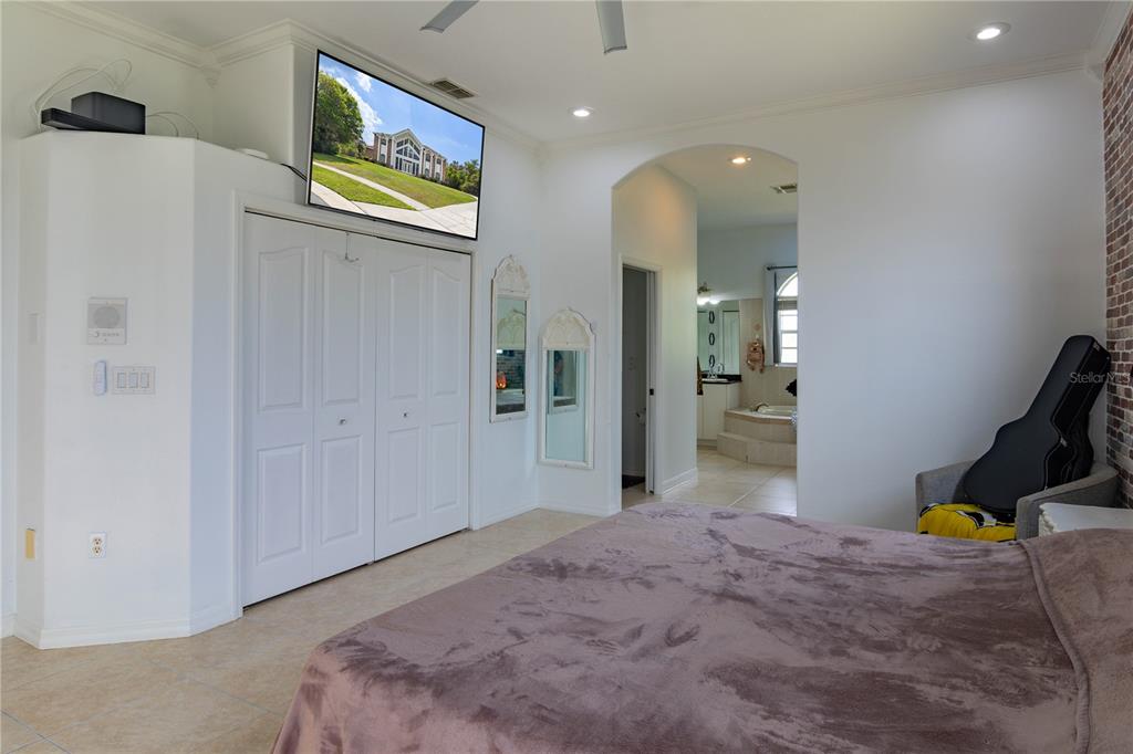 6151 New Osprey Point Weeki Wachee, FL 34607 - Photo 40 of 63 a bedroom with a bed and painting on the wall