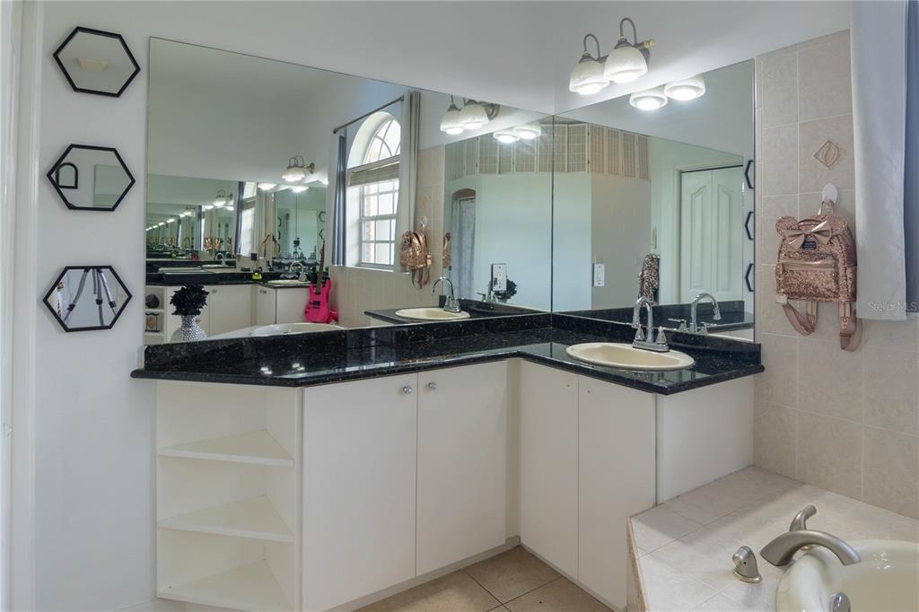 6151 New Osprey Point Weeki Wachee, FL 34607 - Photo 42 of 63 a bathroom with a sink and a mirror