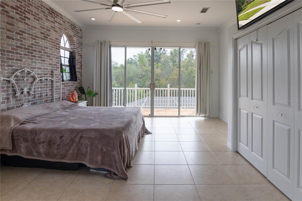 6151 New Osprey Point Weeki Wachee, FL 34607 - Photo 45 of 63 a bedroom with a bed and glass door