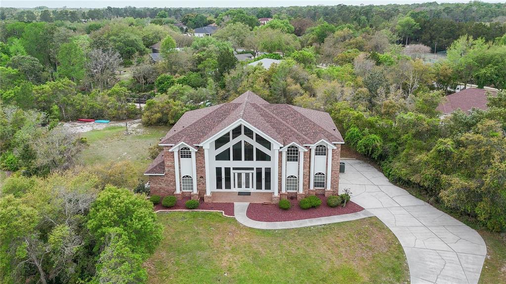 6151 New Osprey Point Weeki Wachee, FL 34607 - Photo 48 of 63 a view of a house with a big yard plants and large trees
