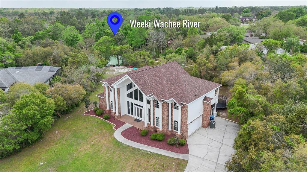 6151 New Osprey Point Weeki Wachee, FL 34607 - Photo 49 of 63 an aerial view of a house with swimming pool and garden