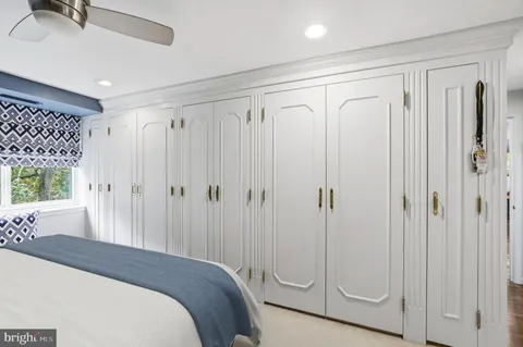 a spacious bedroom with a bed and a shower