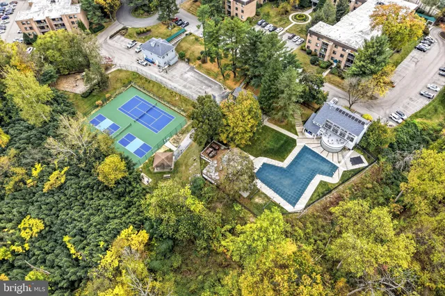 an aerial view of a house with a yard and swimming pool