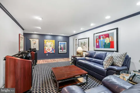 a living room with furniture a rug and a flat screen tv