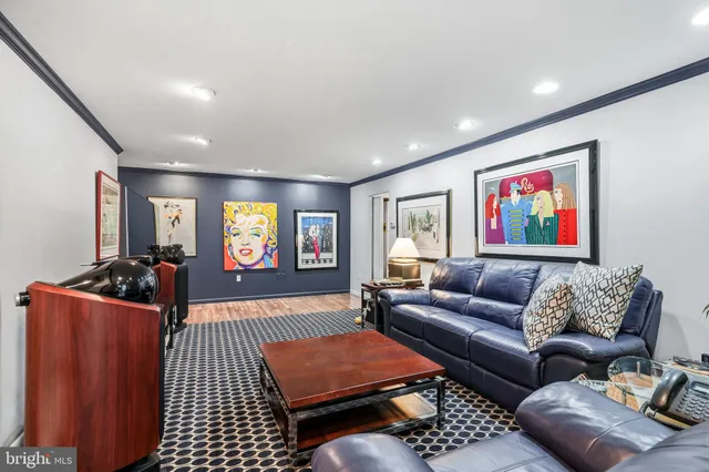 a living room with furniture a rug and a flat screen tv