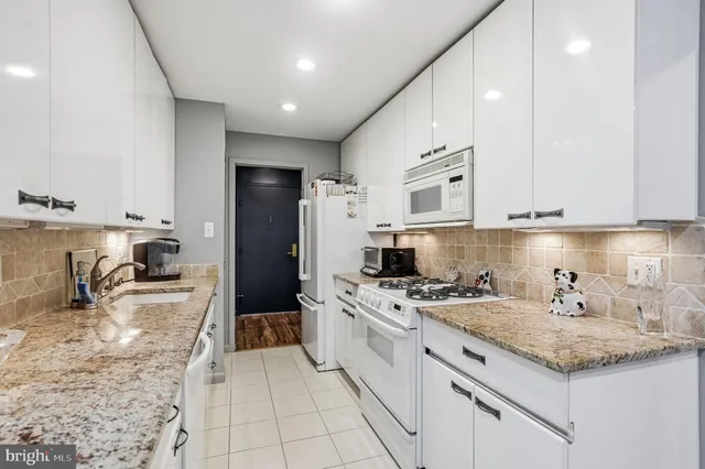 a kitchen with a sink stove and refrigerator