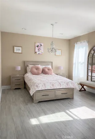 a bedroom with a bed and a chandelier