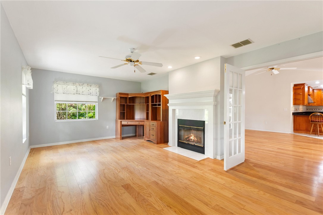 5521 Emerald Ridge Boulevard Lakeland, FL 33813 - Photo 14 of 33 a view of a livingroom with a fireplace a ceiling fan and windows