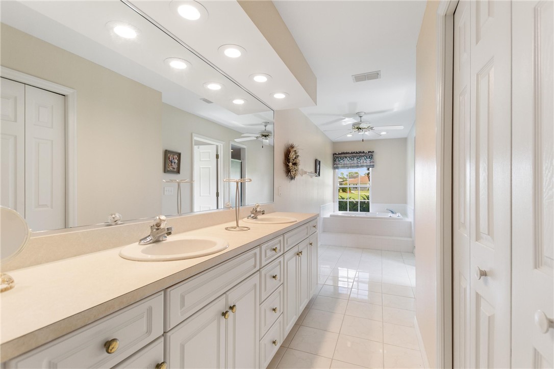 5521 Emerald Ridge Boulevard Lakeland, FL 33813 - Photo 18 of 33 a spacious bathroom with a double vanity sink and a mirror