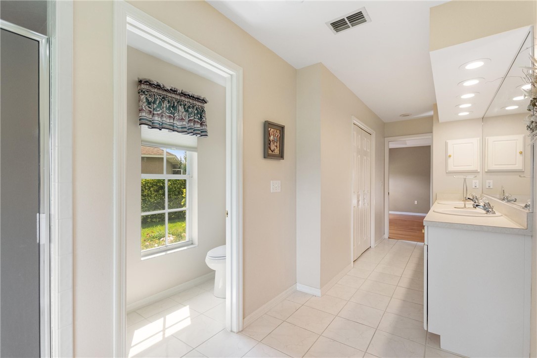5521 Emerald Ridge Boulevard Lakeland, FL 33813 - Photo 20 of 33 a bathroom with a sink a toilet and shower