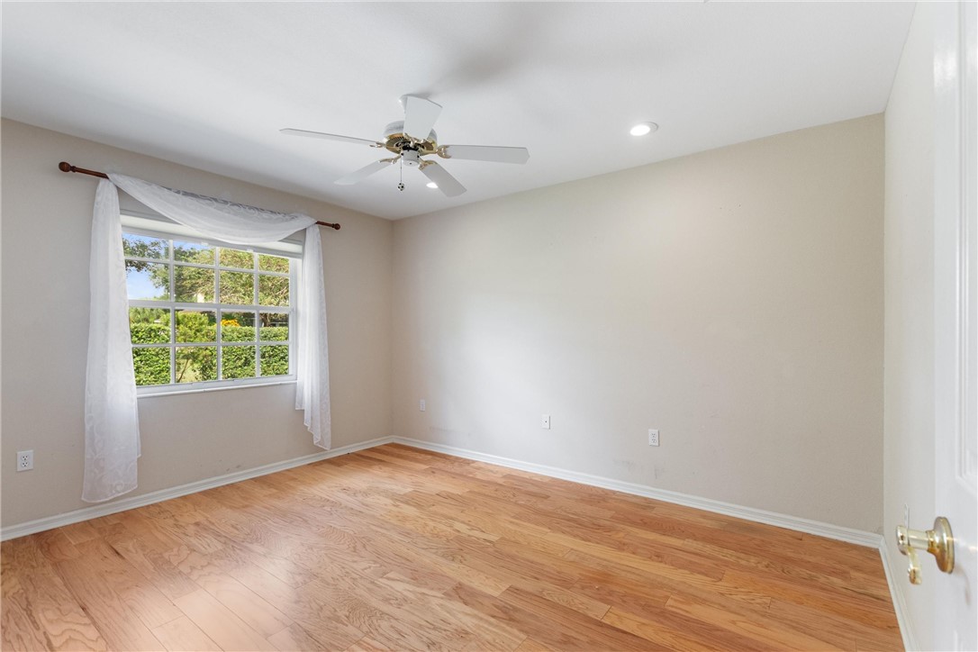 5521 Emerald Ridge Boulevard Lakeland, FL 33813 - Photo 23 of 33 a view of empty room with wooden floor and fan