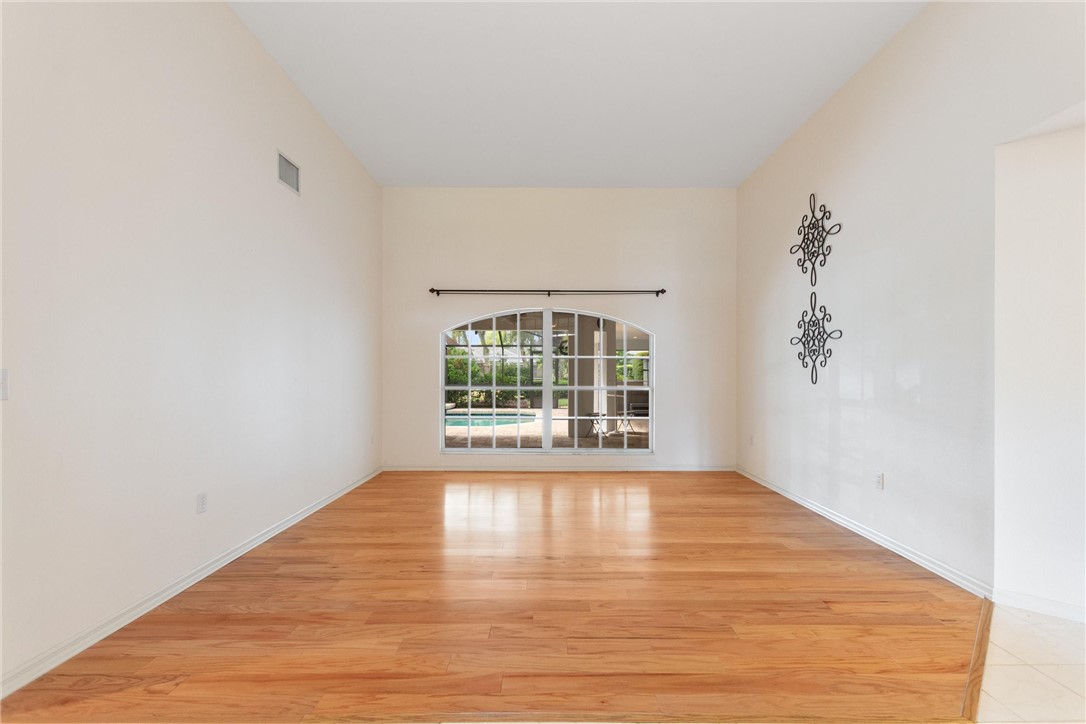 5521 Emerald Ridge Boulevard Lakeland, FL 33813 - Photo 5 of 33 a view of an empty room with wooden floor and a window