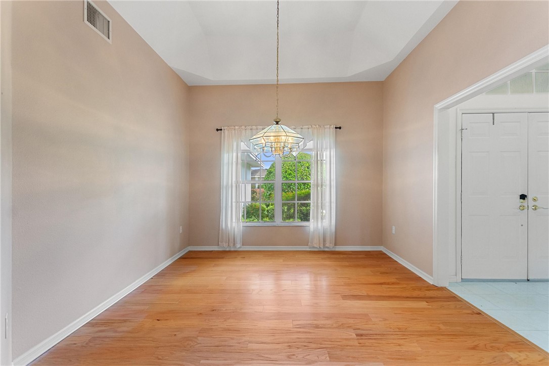 5521 Emerald Ridge Boulevard Lakeland, FL 33813 - Photo 6 of 33 a view of an empty room with wooden floor and a window