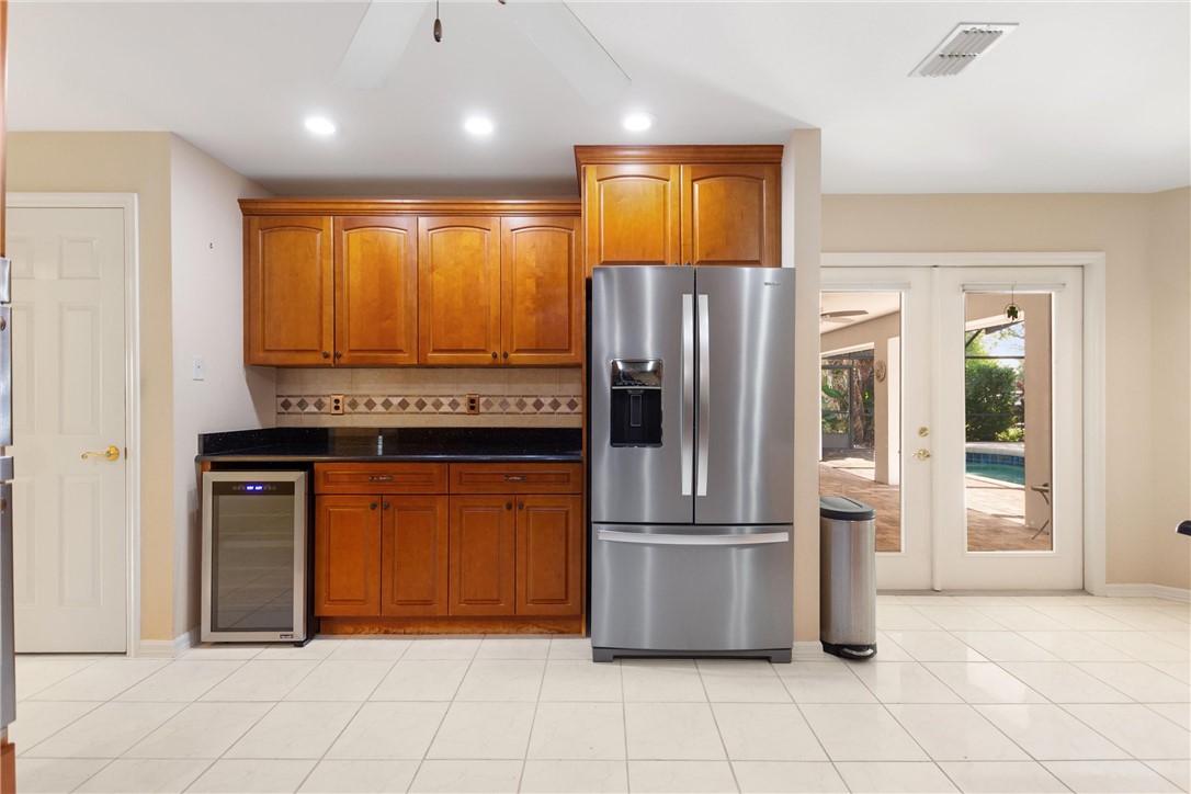 5521 Emerald Ridge Boulevard Lakeland, FL 33813 - Photo 9 of 33 a kitchen with stainless steel appliances granite countertop a refrigerator and a sink