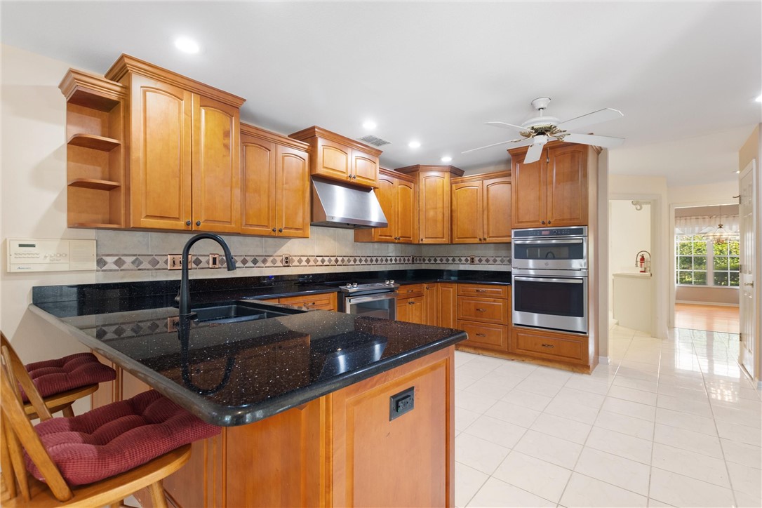 5521 Emerald Ridge Boulevard Lakeland, FL 33813 - Photo 10 of 33 a kitchen with stainless steel appliances granite countertop a sink and cabinets