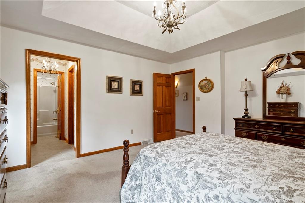 138 Valley Road Eighty Four, PA 15330 - Photo 16 of 33 a bedroom with a bed and a chandelier